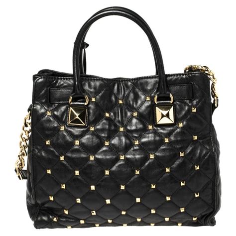 michael kors small black leather purse with tan cloth in|Michael Kors black studded purse.